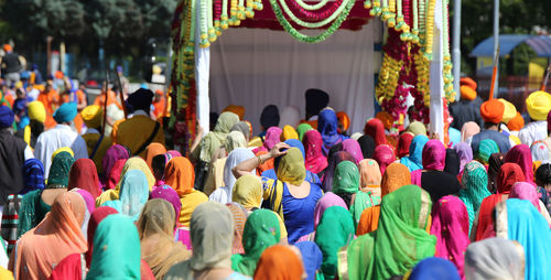 Rear view of people at street in city