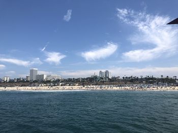 Scenic view of sea and buildings against sky