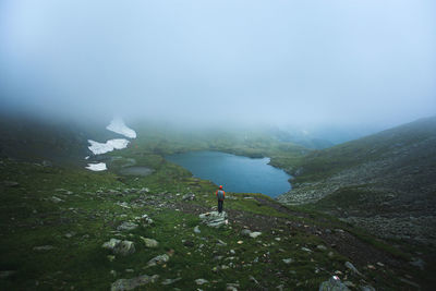 High angle view of man standing on cliff