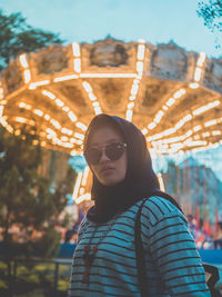 Close-up portrait of young woman in amusement park