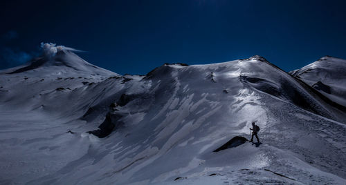 Tourists on snow covered mountain