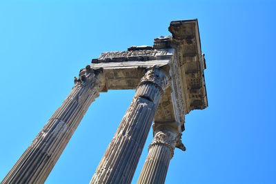 Low angle view of old ruin against clear blue sky