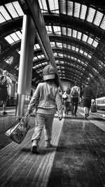 Full length of woman standing by railing