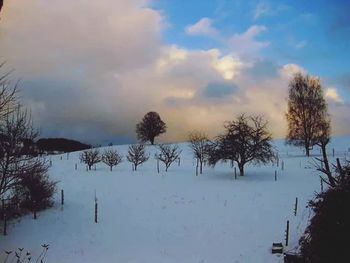 Scenic view of landscape against cloudy sky