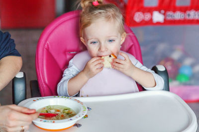 Portrait of young woman eating food