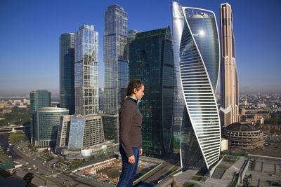 Woman standing on building in city