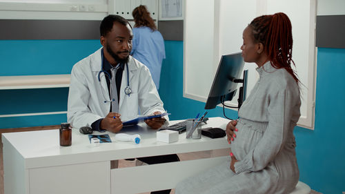 Female doctor examining patient in clinic