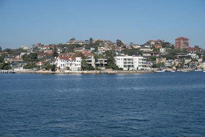 Town by sea against sky