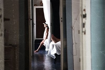 Low section of woman holding umbrella