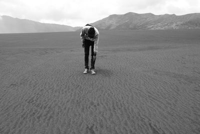 Rear view of man standing on land