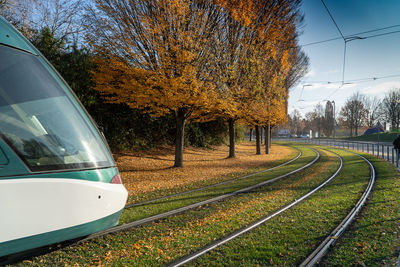 Railroad tracks by trees against sky during autumn