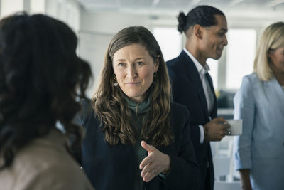 Business people talking during conference break