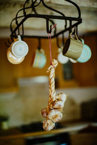 Close-up of light bulb hanging on rope at home