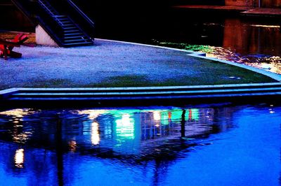 Reflection of illuminated built structure in water