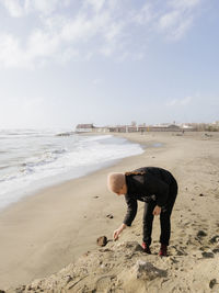 Rear view of woman walking at beach