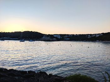 Scenic view of sea against clear sky at sunset