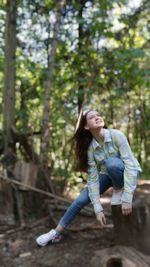 Full length of a young woman in the forest