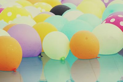 Close-up of multi colored balloons in water