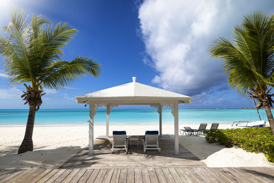 Lifeguard hut on beach against sky