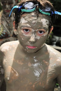 Young boy in mud bath