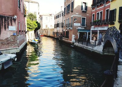 Canal amidst buildings in city