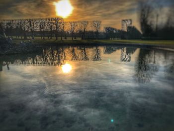 Scenic view of lake against sky during sunset