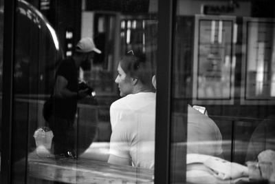 Reflection of people on glass window in restaurant