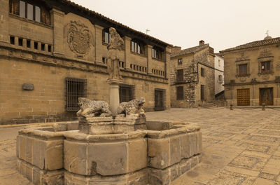 Medieval fountain in  a square of baeza, an old town in jaen province, andalusia, spain