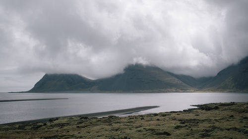 Scenic view of sea and mountains against sky