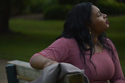 Woman sitting on bench at park