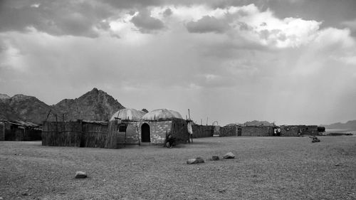 Wrecked old village in the desert on egypt against a cloudy sky