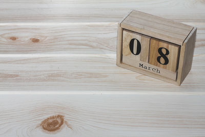 Close-up of text and number on wooden block