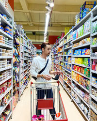 Full length of man looking at store