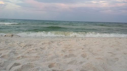 Scenic view of sea against cloudy sky