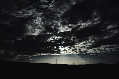 Low angle view of silhouette trees against sky