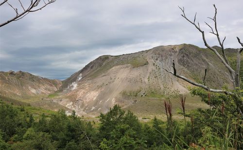 Scenic view of volcanic mountains against sky