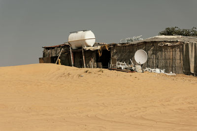 View of hut on sand dune