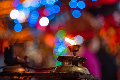 Close-up of illuminated candle at night