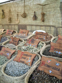 Row of spices in basket with labels at market stall