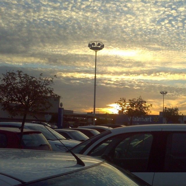 sunset, transportation, sky, car, cloud - sky, street light, mode of transport, tree, land vehicle, sun, road, the way forward, silhouette, orange color, street, sunlight, cloud, nature, cloudy, no people