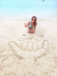 Full length of smiling woman on beach