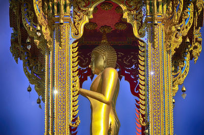 Statue of buddha against building