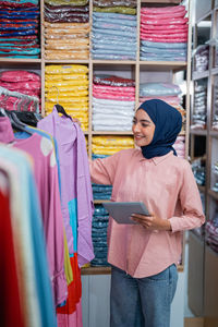 Portrait of young woman standing in store