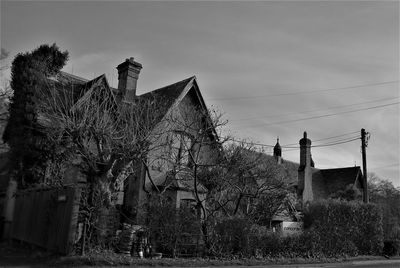 Exterior of old house on field against sky