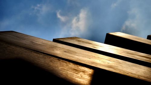 Low angle view of wood against sky