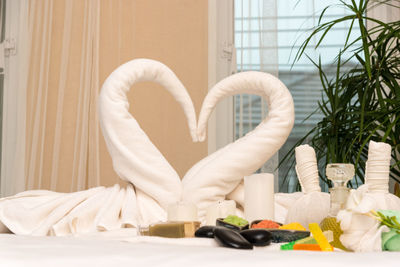 Heart shape towels on bed at spa in luxury hotel