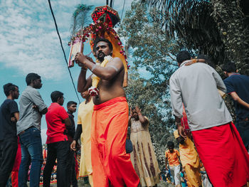 People in traditional clothing standing against sky