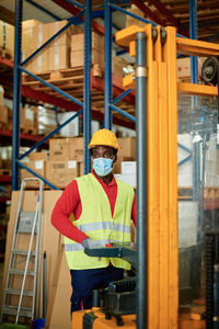 Rear view of man working in factory