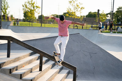 Rear view of man skateboarding on skateboard