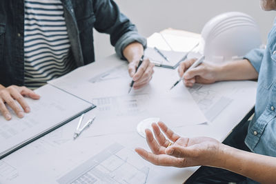 Midsection of man working on table